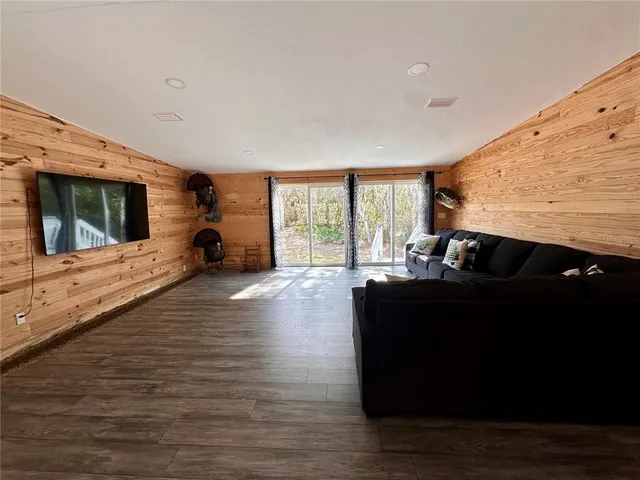 a view of water heater room with wooden floor