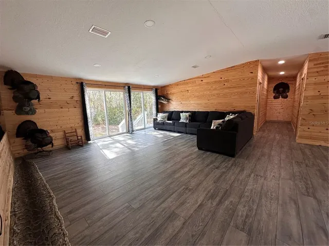 a view of a livingroom with furniture window and wooden floor
