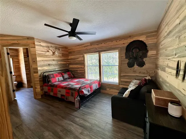 a bedroom with a bed and a night stand