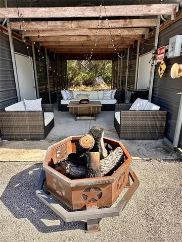 an aerial view of a house with yard and sitting area
