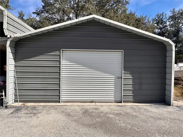 a view of a backyard with plants and outdoor seating