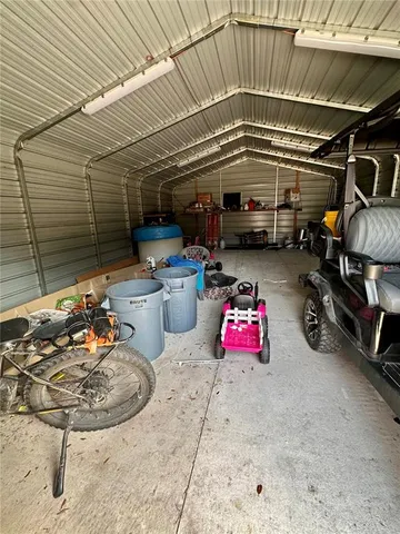 a view of a chairs and a table in the backyard