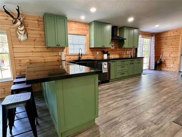a kitchen with stainless steel appliances granite countertop a refrigerator and cabinets