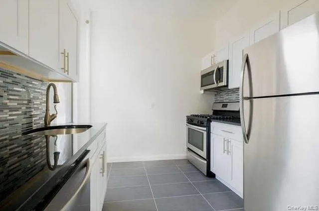 a kitchen with a refrigerator stove and microwave