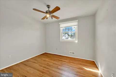 a view of a big room with wooden floor and natural light