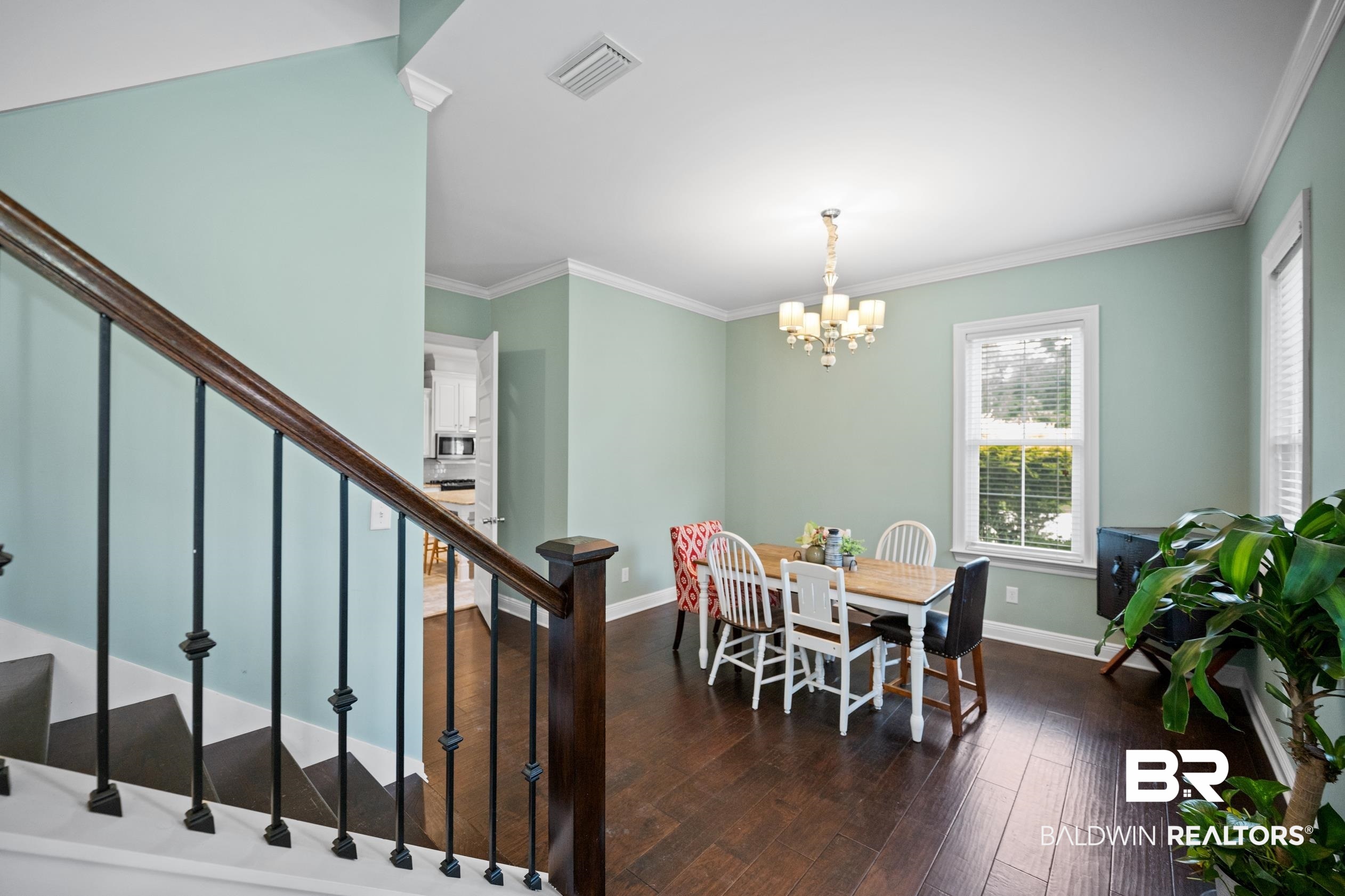9060 Bromley Road Bay Minette, AL 36507 - Photo 14 of 63 Dining area with plenty of natural light, stairs, a chandelier, dark wood finished floors, and ornamental molding