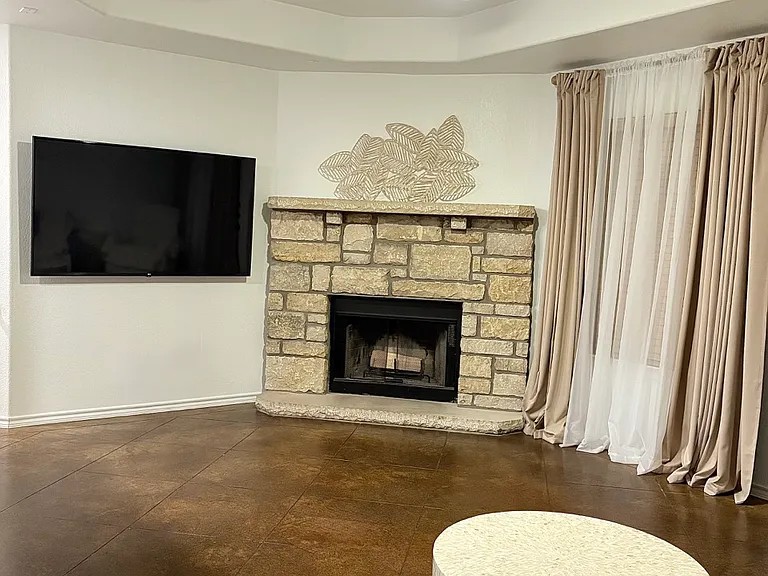 430 Summit Ridge Drive North Point Venture, TX 78645 - Photo 4 of 26 A corner fireplace crafted from natural stone anchors this inviting living area.