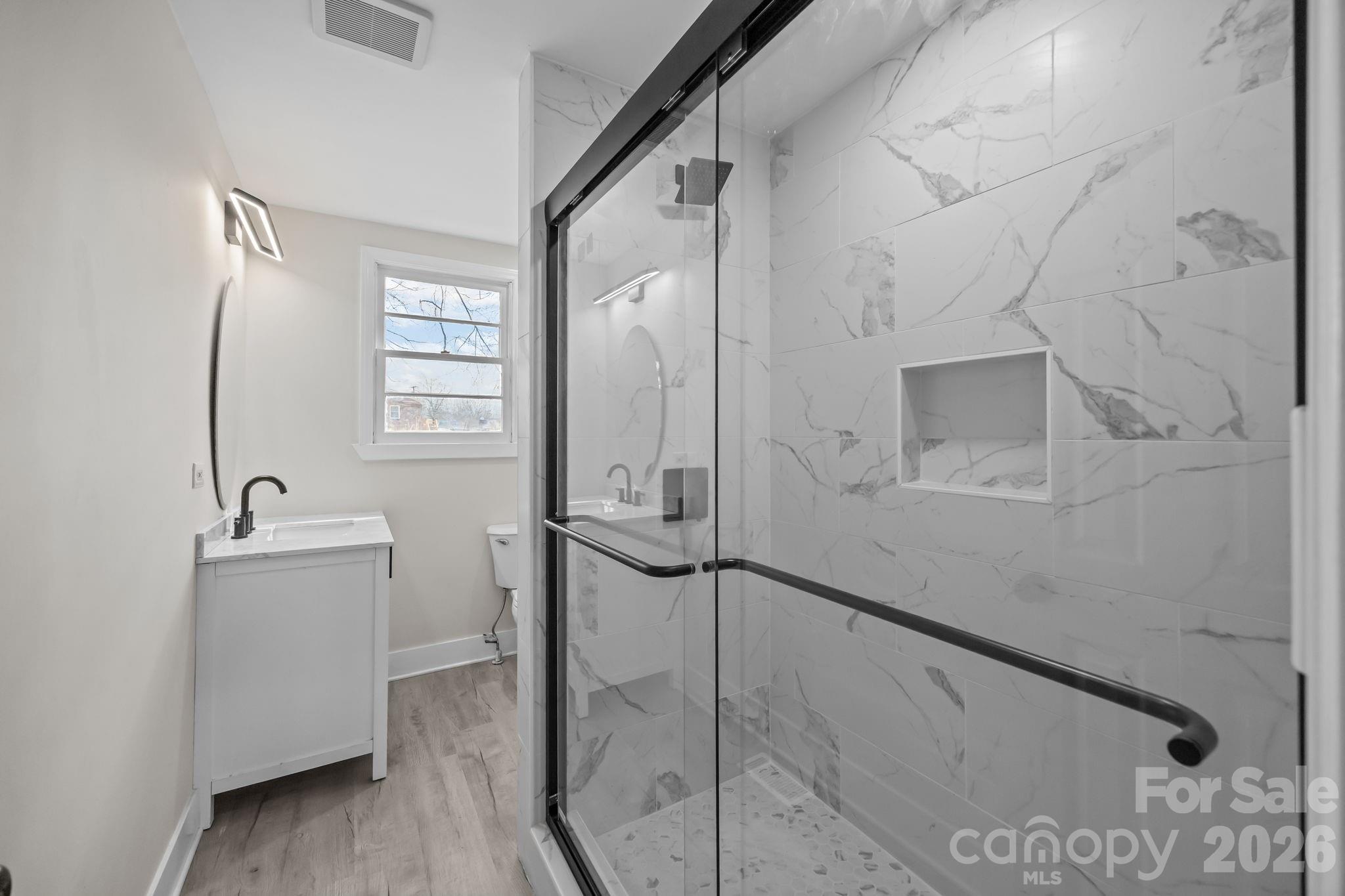 511 East Trade Street Dallas, NC 28034 - Photo 11 of 16 a bathroom with a bathtub and sink