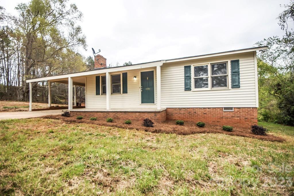 8998 Mt Olive Road Mount Pleasant, NC 28124 - Photo 1 of 15 a front view of a house with a yard
