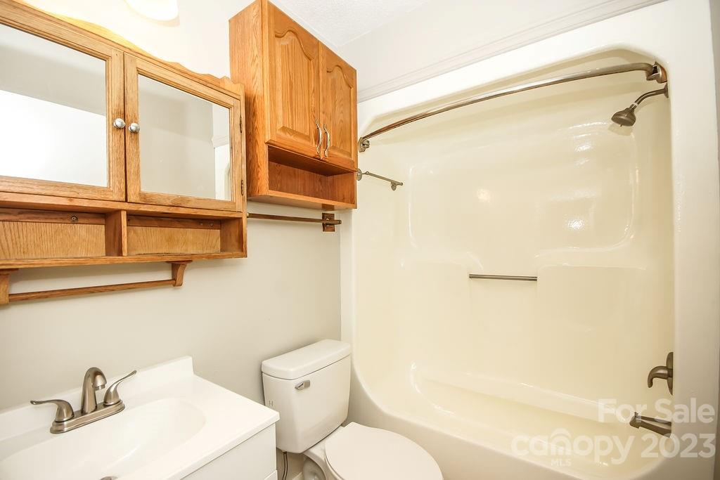 8998 Mt Olive Road Mount Pleasant, NC 28124 - Photo 15 of 15 a bathroom with a sink a toilet and shower