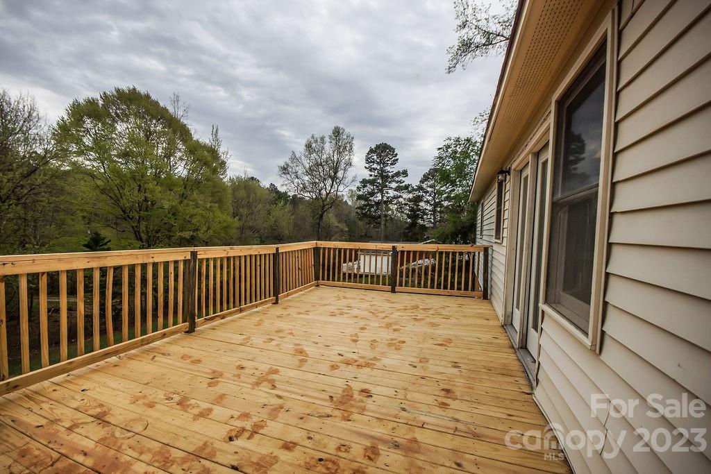 8998 Mt Olive Road Mount Pleasant, NC 28124 - Photo 3 of 15 a view of balcony with wooden floor and fence