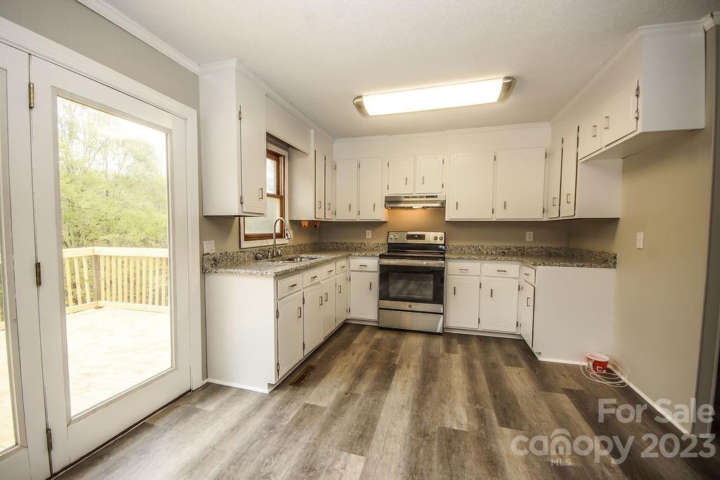 8998 Mt Olive Road Mount Pleasant, NC 28124 - Photo 6 of 15 a kitchen with granite countertop white cabinets and white appliances