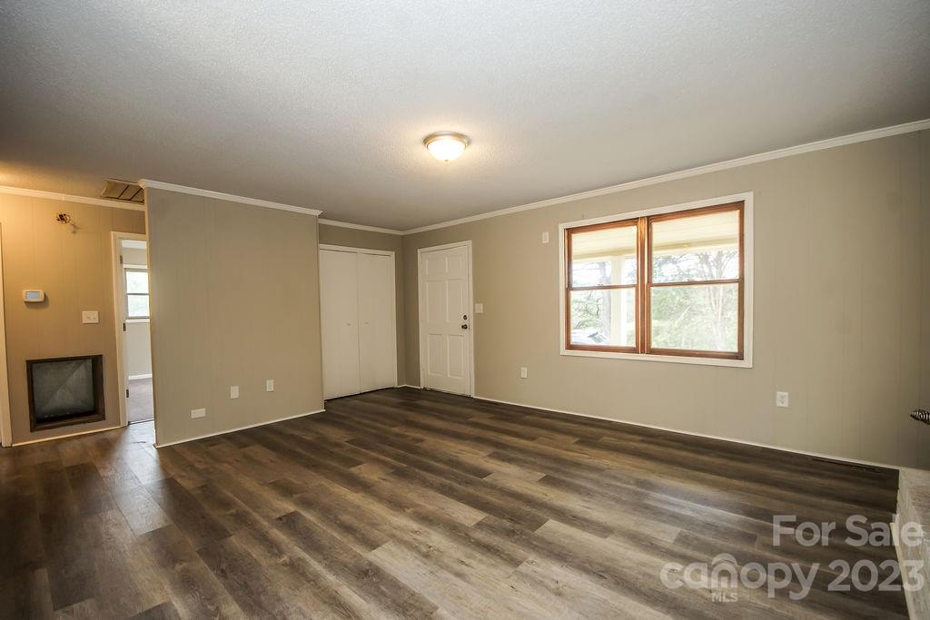 8998 Mt Olive Road Mount Pleasant, NC 28124 - Photo 8 of 15 a view of an empty room with window and wooden floor