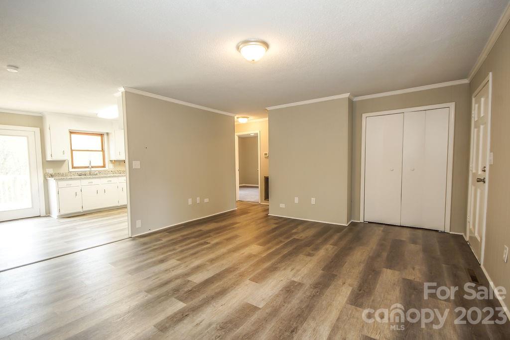 8998 Mt Olive Road Mount Pleasant, NC 28124 - Photo 9 of 15 an empty room with wooden floor and windows