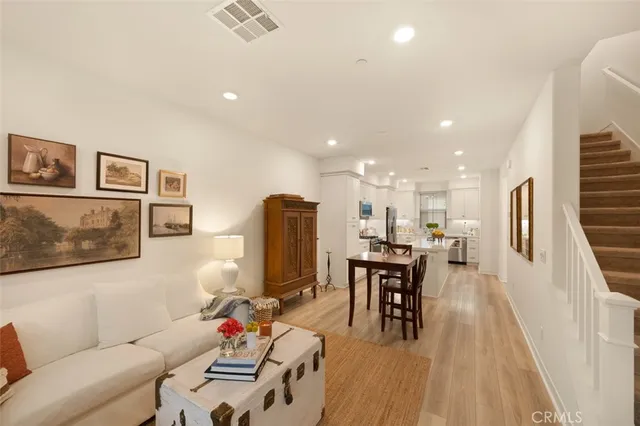 a living room with furniture and kitchen view
