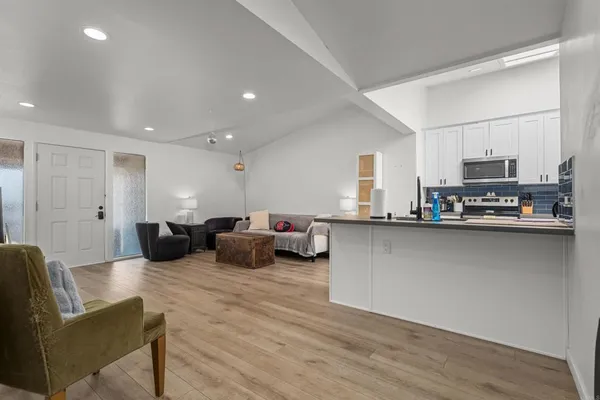 a living room with furniture and a wooden floor