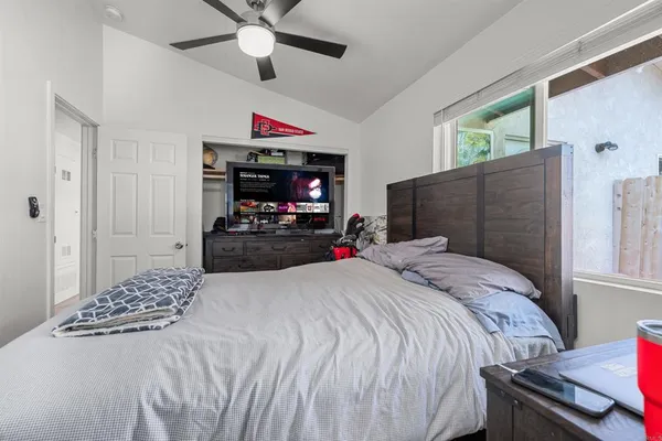 a bedroom with a bed and a flat screen tv