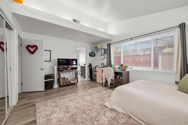 a bedroom with bed and a tv