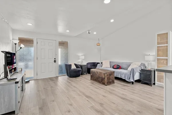 a living room with furniture and a wooden floor