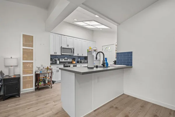 a kitchen with a sink cabinets and wooden floor