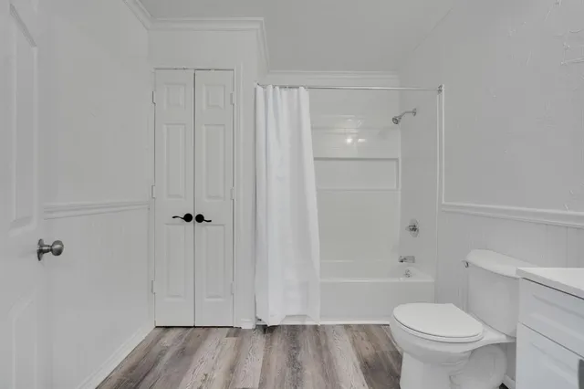a bathroom with a toilet and a shower