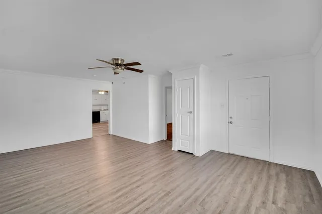 a view of a livingroom with a hardwood floor and a ceiling fan
