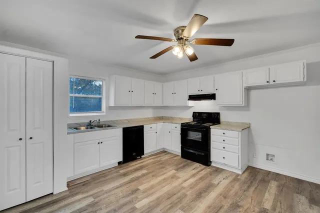 a kitchen with a stove a sink and a refrigerator