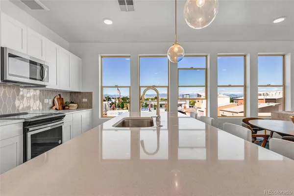 a kitchen with stainless steel appliances granite countertop a stove and a sink with granite countertops