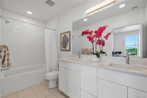 a bathroom with a granite countertop sink mirror and toilet