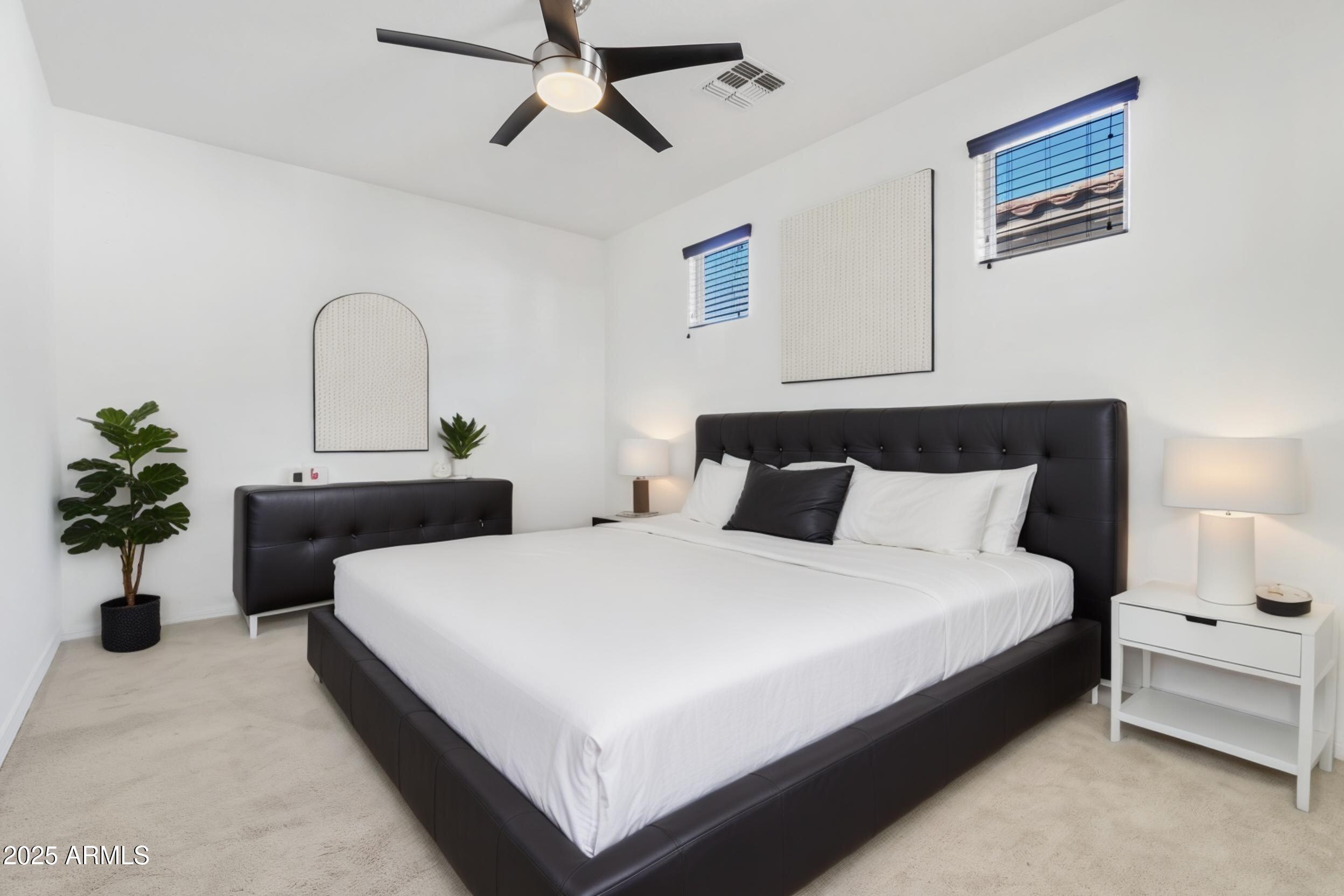 2365 North Springfield Street Buckeye, AZ 85396 - Photo 17 of 30 a bedroom with bed and a potted plant