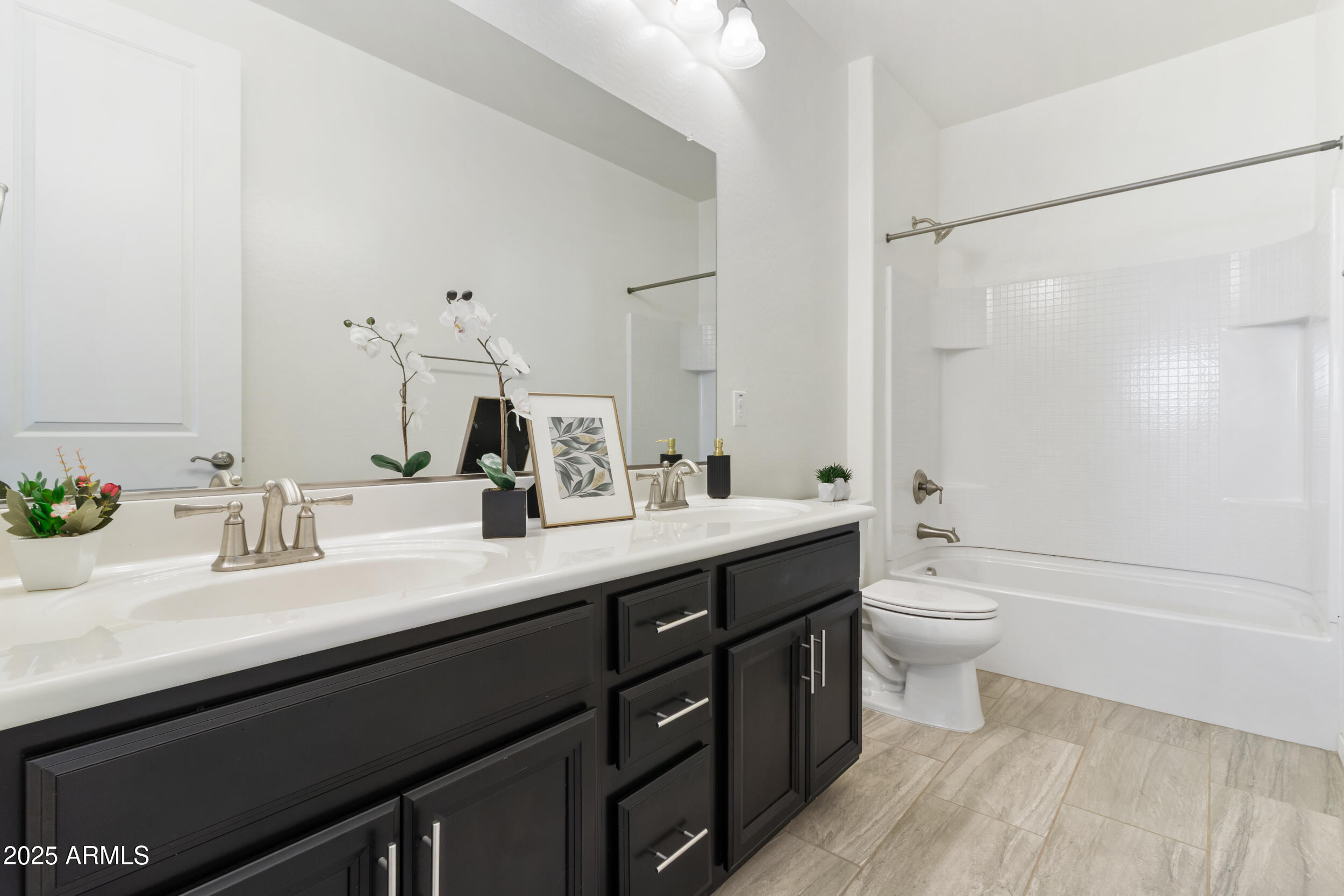 2365 North Springfield Street Buckeye, AZ 85396 - Photo 18 of 30 a bathroom with a double vanity sink toilet and shower