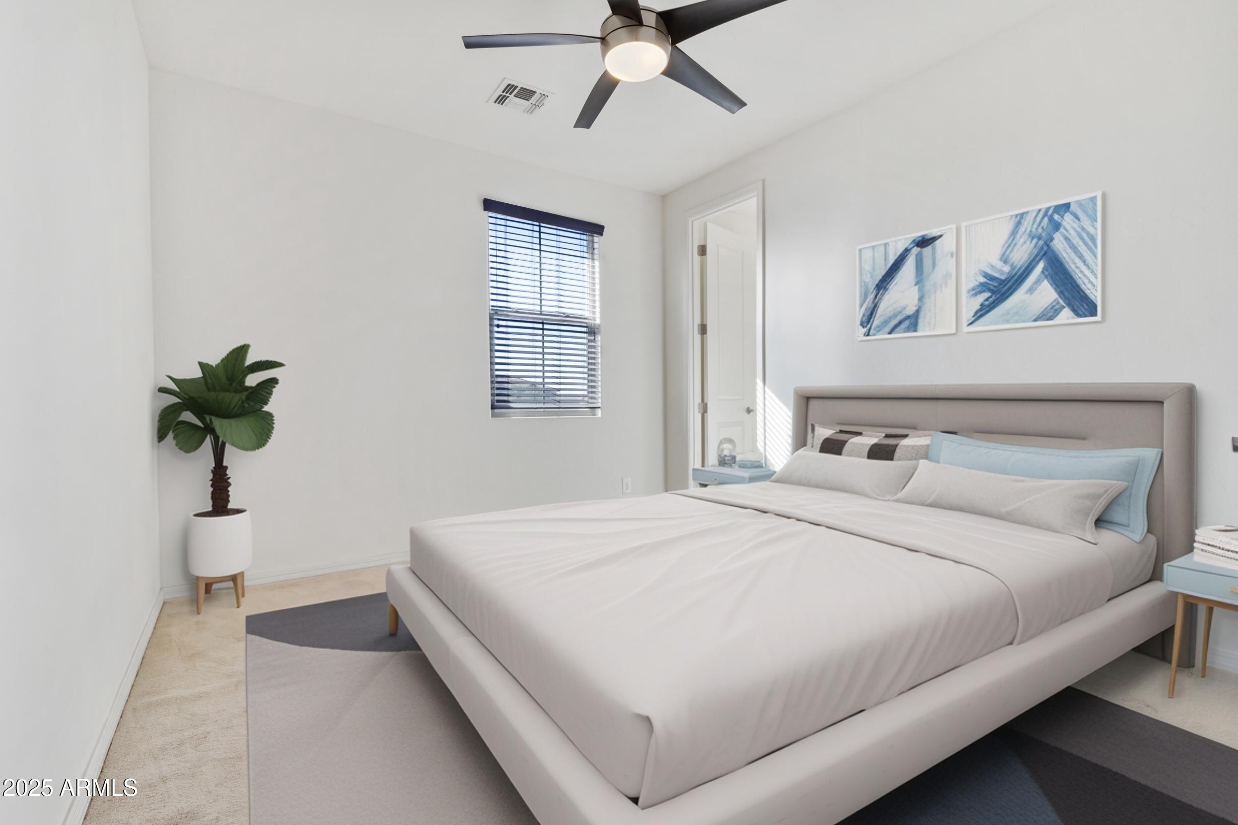 2365 North Springfield Street Buckeye, AZ 85396 - Photo 19 of 30 a bedroom with a large bed and a chandelier