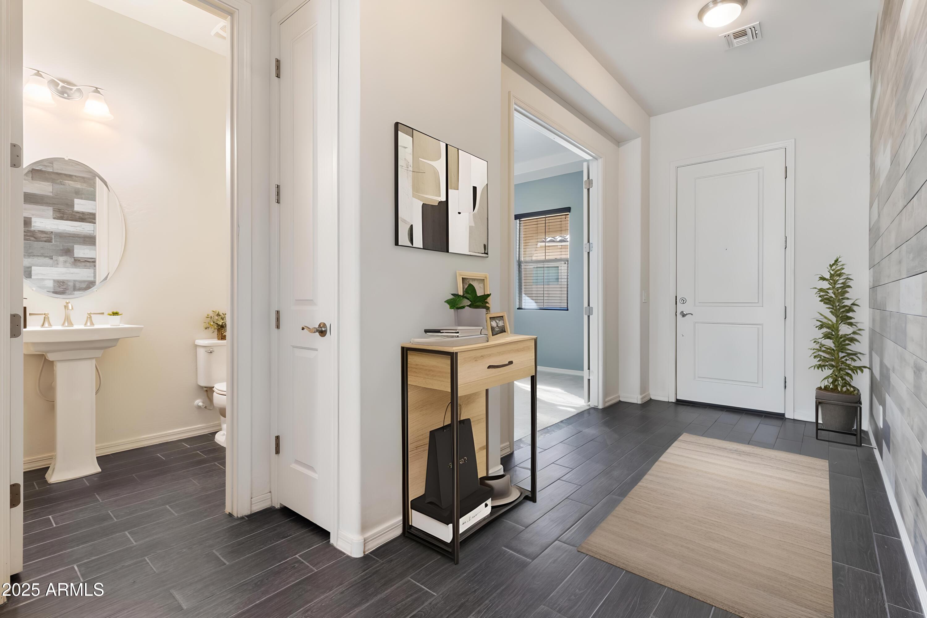2365 North Springfield Street Buckeye, AZ 85396 - Photo 2 of 30 a view of a hallway with wooden floor and a bathroom