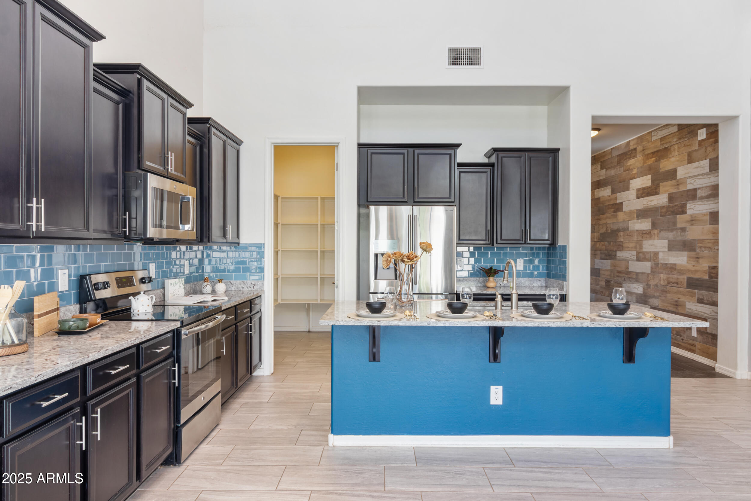2365 North Springfield Street Buckeye, AZ 85396 - Photo 5 of 30 a kitchen with stainless steel appliances granite countertop a sink stove and cabinets