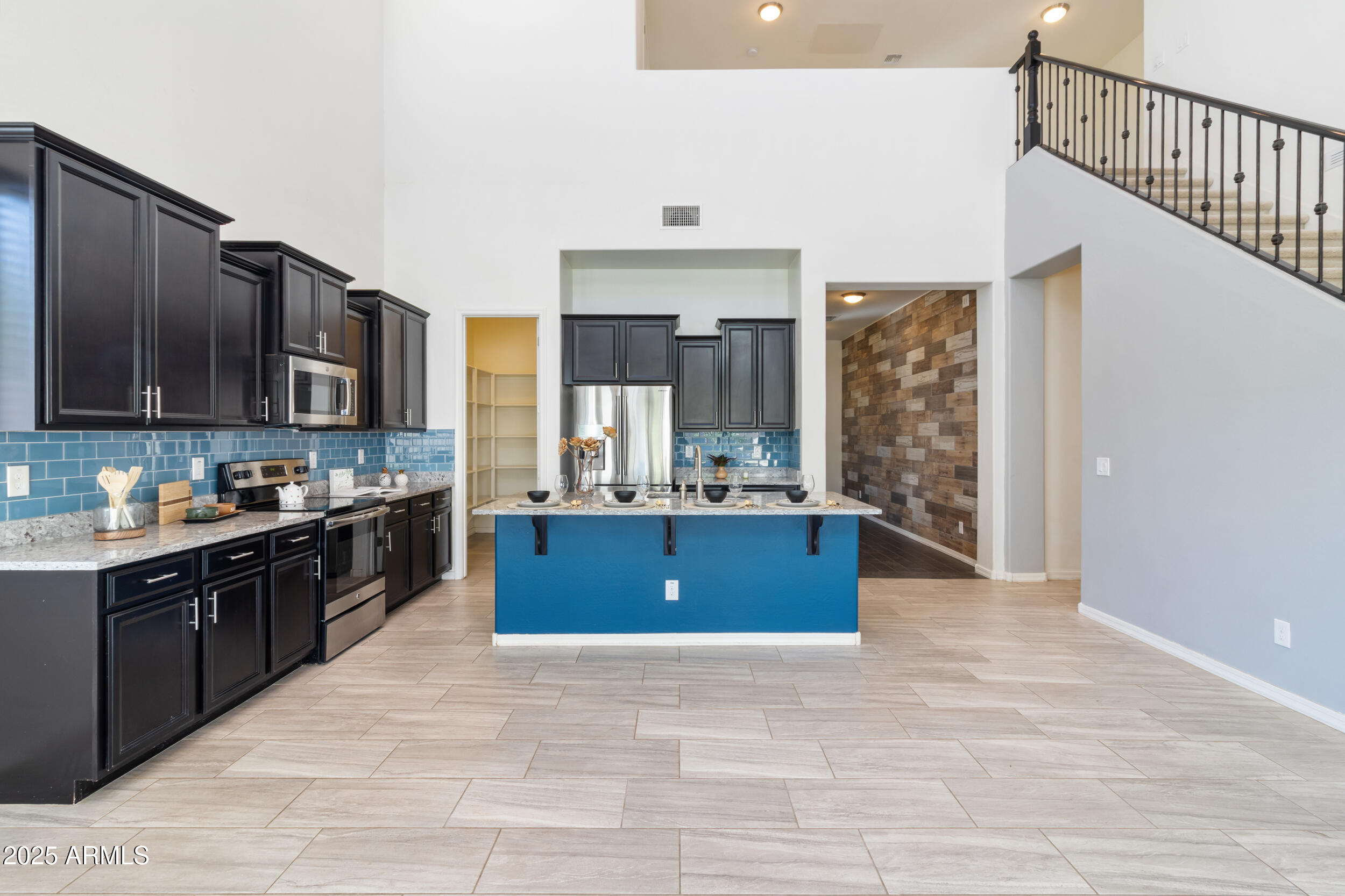 2365 North Springfield Street Buckeye, AZ 85396 - Photo 6 of 30 a large kitchen with stainless steel appliances granite countertop a stove a sink dishwasher a microwave oven with granite countertops and cabinets