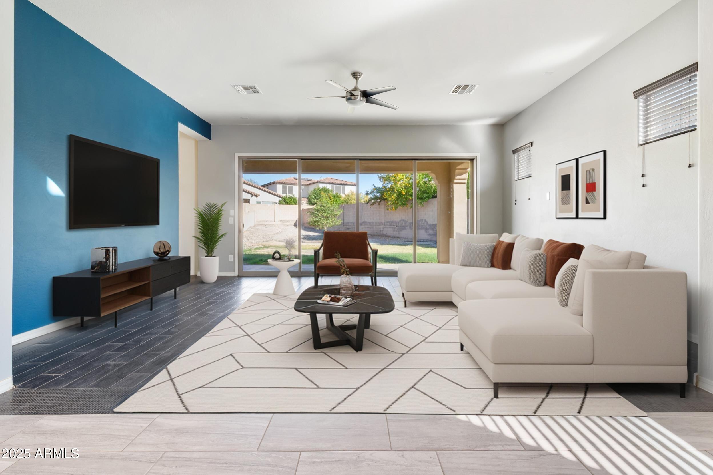 2365 North Springfield Street Buckeye, AZ 85396 - Photo 7 of 30 a living room with furniture and a flat screen tv