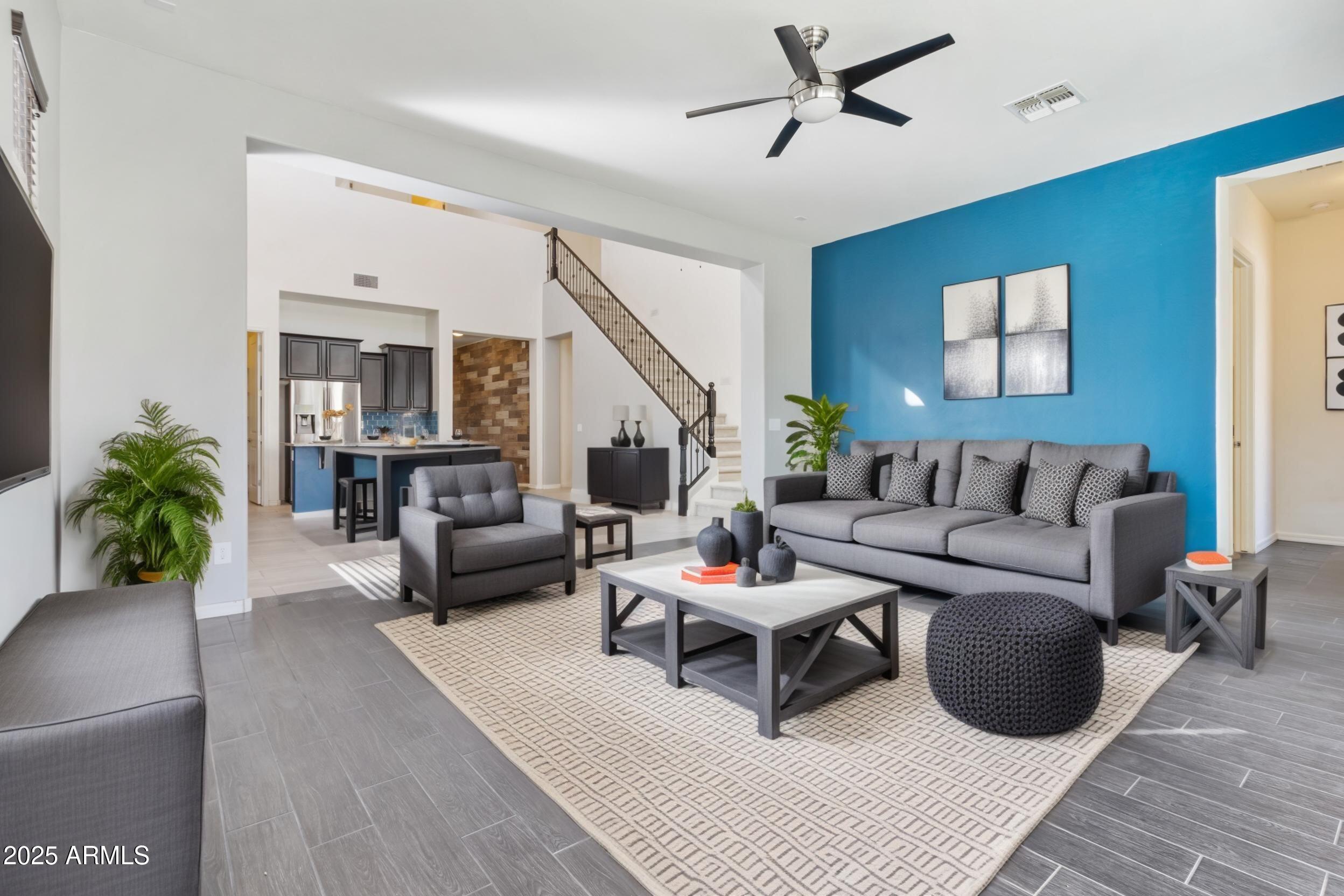2365 North Springfield Street Buckeye, AZ 85396 - Photo 9 of 30 a living room with furniture and a potted plant