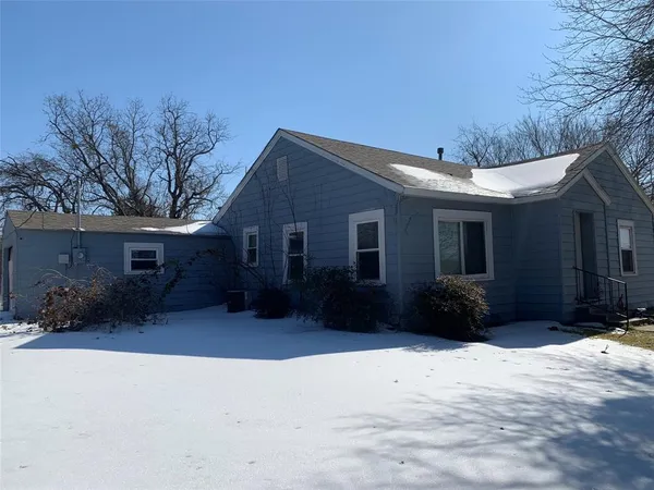 a view of a house with a yard covered in snow