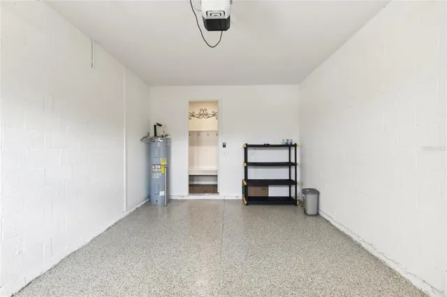 an empty room with a cabinet and mirrors