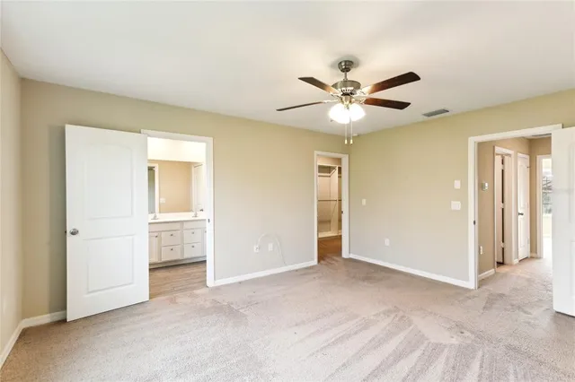 a view of an empty room with a ceiling fan