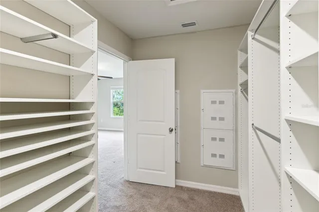 a view of walk in closet with empty racks