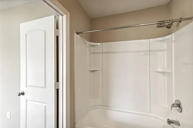 a bathroom with a shower and a glass door