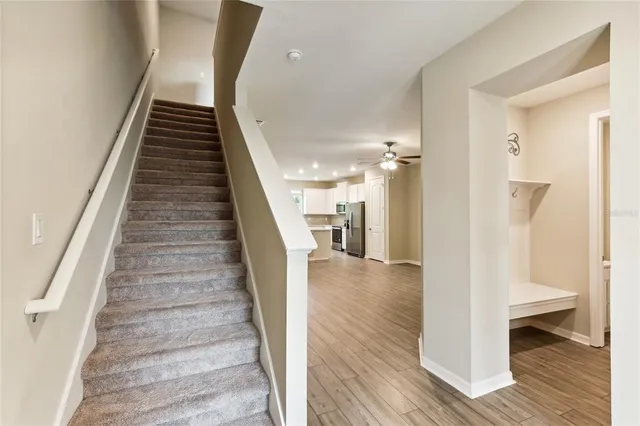 a view of entryway and hall with wooden floor