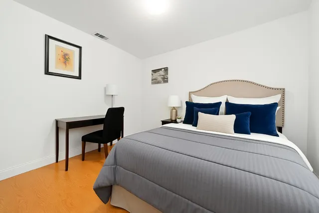 a bedroom with a bed and a desk