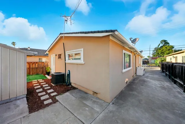 a view of a house with backyard and sitting area