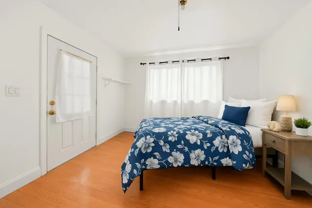 a bedroom with a bed and window