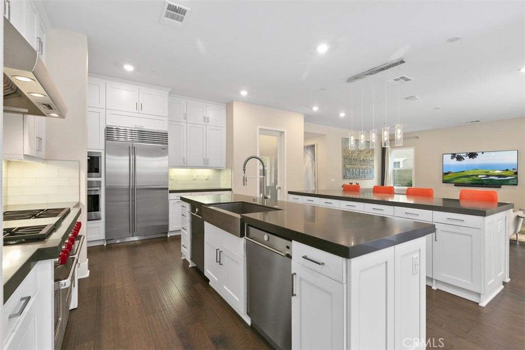 79 Gravity Irvine, CA 92618 - Photo 15 of 70 a kitchen with stainless steel appliances granite countertop a sink a stove and a refrigerator