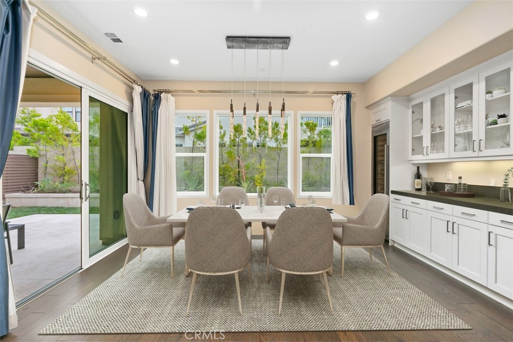 79 Gravity Irvine, CA 92618 - Photo 16 of 70 a view of a dining room with furniture large windows and wooden floor