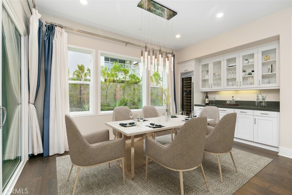 79 Gravity Irvine, CA 92618 - Photo 17 of 70 a dining room with furniture large windows and a chandelier