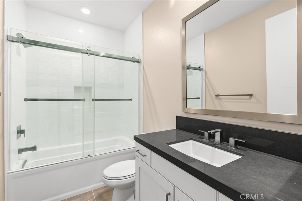 79 Gravity Irvine, CA 92618 - Photo 41 of 70 a bathroom with a double vanity sink toilet mirror and shower